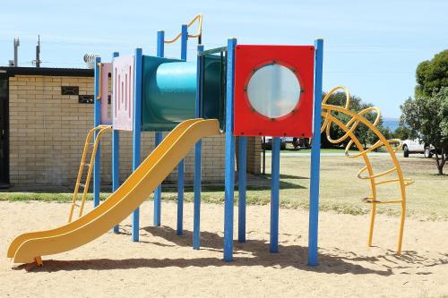 a playground with a slide and a slideintend at Port Lincoln Caravan Park in North Shields