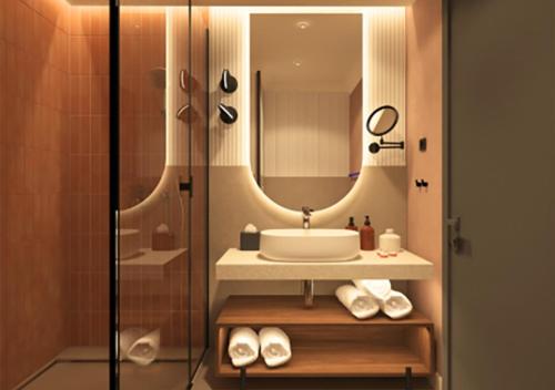 a bathroom with a sink and a mirror at Hotel Trianon in Bucharest