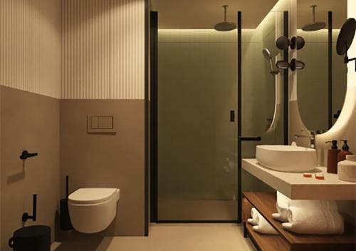 a bathroom with a toilet and a sink and a shower at Hotel Trianon in Bucharest