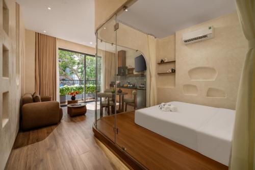 a bedroom with a large white bed and a dining room at Bullani-Sabi Hotel & Apartment in Da Nang
