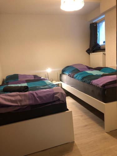 Ένα ή περισσότερα κρεβάτια σε δωμάτιο στο Jolie Appartement Bei Kassel
