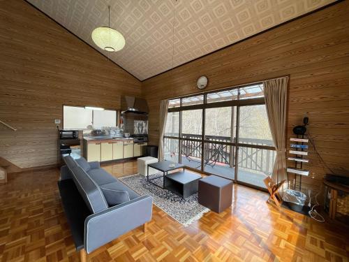 a living room with a couch and a table at Forest villa lake yamanaka in Wada