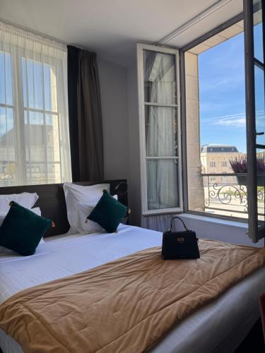 a bedroom with a bed with a large window at Best Western Blois Château in Blois