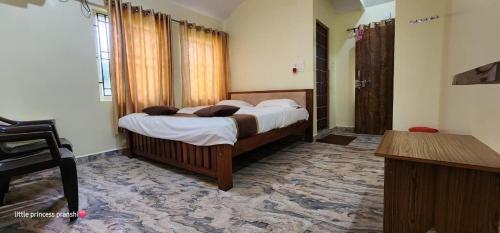 a bedroom with a large bed in a room at Leela Grove Cottages Gokarna in Gokarna