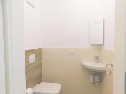 a bathroom with a toilet and a sink at FeWo "Hafenblick" in Barth