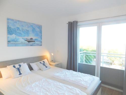 a bedroom with a bed and a large window at FeWo "Hafenblick" in Barth