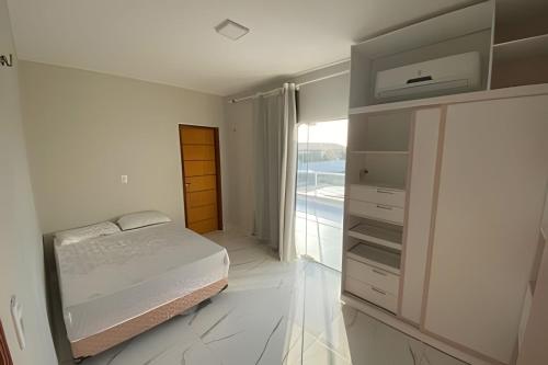 Postel nebo postele na pokoji v ubytování Eficiência - Casa Recanto dos Ventos