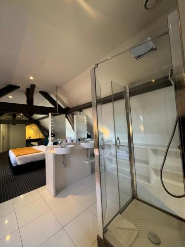 a bathroom with a shower and a bedroom at Best Western Blois Château in Blois