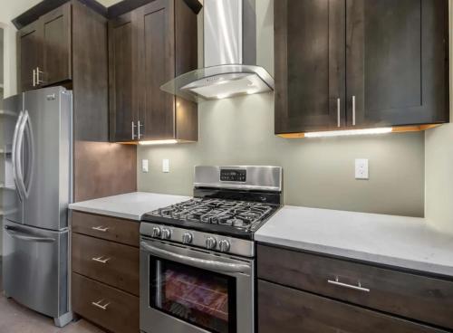 a kitchen with a stove and a refrigerator at Modern Mountain Retreat Single Level Living in Glenwood Springs