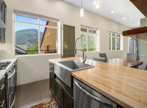 a kitchen with a sink and a large window at Modern Mountain Retreat Single Level Living in Glenwood Springs