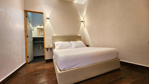 a bedroom with a bed in a small room at Casa Antonio Mazunte in Mazunte