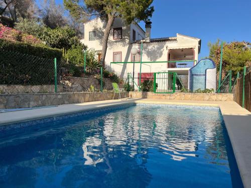 a swimming pool in front of a house at La Casa Maria in Pego