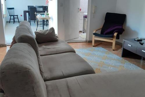 a living room with a couch and a chair at 2-Bed House - Garden Parking Pets in Viana do Castelo