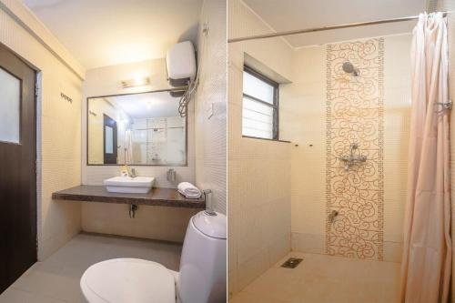 a bathroom with a toilet and a sink and a shower at Hidden Gem 3bhk with unlimited internet in Candolim