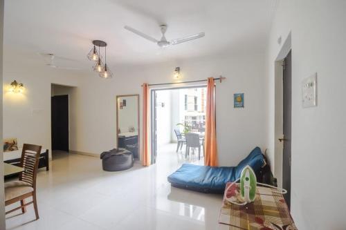 a living room with a blue bean bag chair and a table at Hidden Gem 3bhk with unlimited internet in Candolim