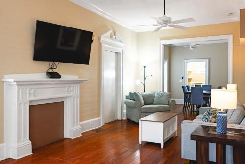a living room with a fireplace and a tv at Sweet Caroline in Key West