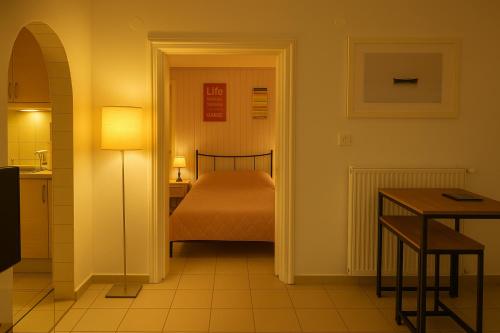 a room with a bedroom with a bed and a table at Country house in Vrahati