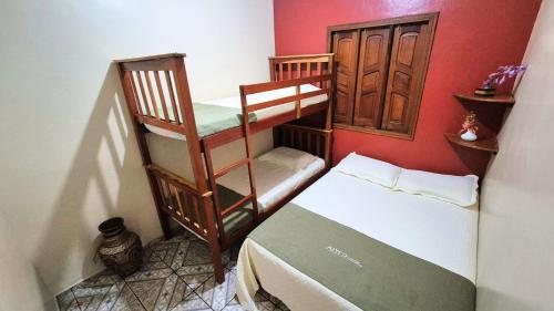 a small room with two bunk beds and a bed at Recanto das Palmeiras Alter do Chão in Alter do Chao