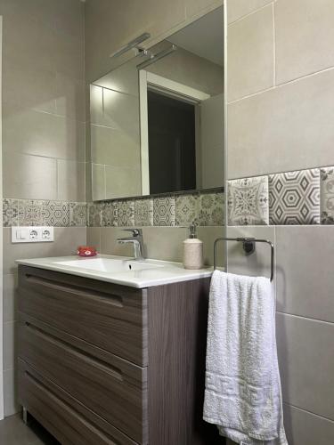 a bathroom with a sink and a mirror at La terraza de la subbética in Luque