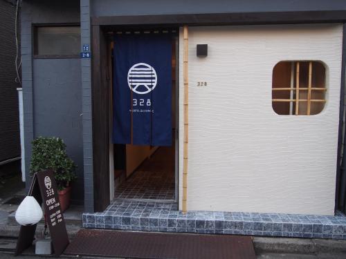 a white garage door with a sign on it at 328 Hostel & Lounge in Tokyo