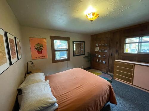 a bedroom with a bed and a dresser in it at Farmhouse Cabin in the Redwoods in Eureka
