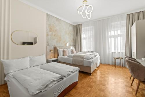 a bedroom with two beds and a mirror at Near Schönbrunn I 1 Min to U6 Niederhofstraße in Vienna