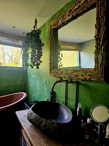 a bathroom with a black sink and a mirror at Villa in the forest of Amsterdam with Pool in Velsen-Zuid