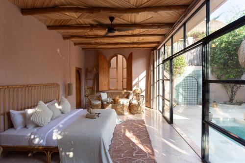 a bedroom with a bed and a large window at Villa Pinkaboo - Gorgeous and Luxury One-Bedroom Villa in the Heart of Canggu in Canggu