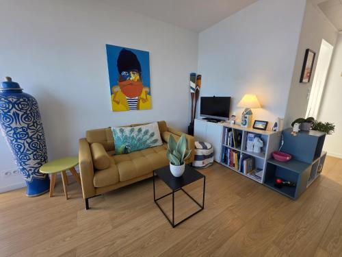 a living room with a couch and a table at Joli cocon vue mer exceptionnelle proche plages in Plouguerneau