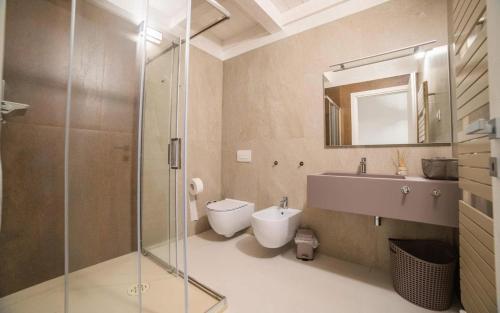a bathroom with a shower and a toilet and a sink at RESIDENCE OLD STORIES in Barile