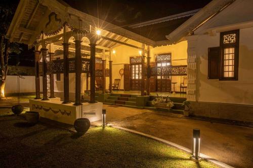 a building with lights in a courtyard at night at Elephant Heritage Pinnawala by Moon Isle in Rambukkana