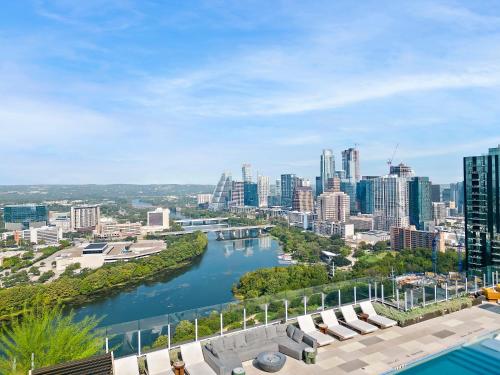 a view of the city from the roof of a building at Rainey St 1BR - Heated Pool - Gym - Bar - DT ATX in Austin