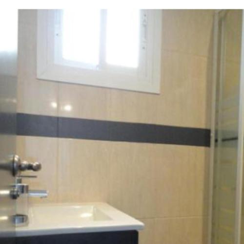 a bathroom with a sink and a shower at Atico primera linea del mar in Sitio de Calahonda