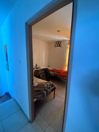 a view of a room with a bed and a mirror at Habitación en Residencia Mendoza Ciudad in Mendoza