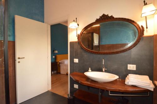a bathroom with a sink and a mirror on the wall at Volpicelli B&B in Civitella Alfedena
