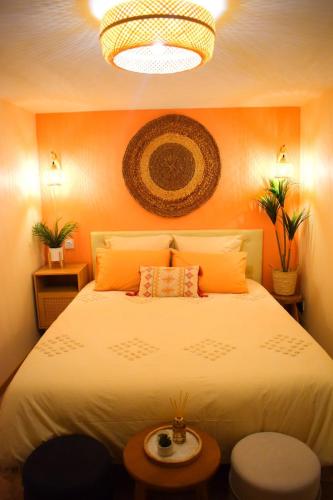 ein Schlafzimmer mit einem großen Bett mit einer orangefarbenen Wand in der Unterkunft La Verrière in Poitiers