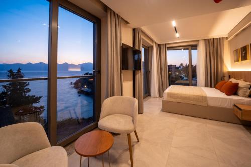 a hotel room with a bed and a large window at Reev Coffee House in Antalya