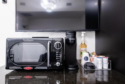 a microwave sitting on top of a kitchen counter at Hollyhock Suite 509 in Louisville