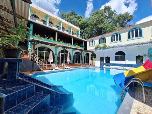a swimming pool in front of a building at Ribiera del Lago Peten Itza in Flores