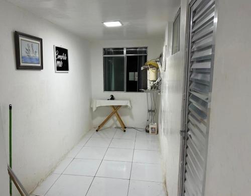 a room with a white tile floor and a sink at Apartamento na graça, 03 suítes, Sua melhor opção em Salvador in Salvador