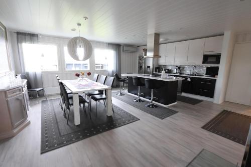 a kitchen and dining room with a table and chairs at Luxury Apartment in the Heart of Pello in Pello