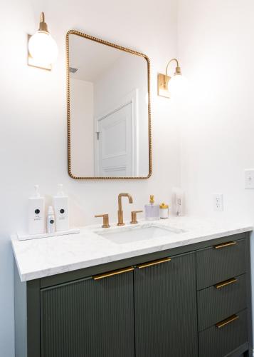 a bathroom with a sink and a mirror at Hollyhock Suite 507 in Louisville
