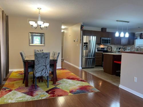 a kitchen and dining room with a table and chairs at Spacious and Charming Bungalow Retreat (Close to Many Amenities) in Kingston