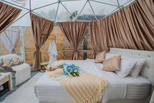 Un dormitorio con una cama en una tienda de campaña. en ภูชี้ฟ้า นาราวิวล์แอดภูชี้ฟ้า Naraview at phuchifa, en Thoeng