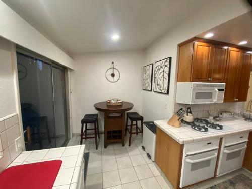a kitchen with a counter and a table with chairs at Sunny Lakeview Retreat - Private Beach Access in Skyland