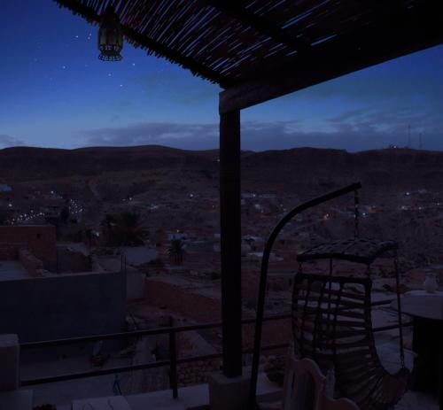 a view from the roof of a building at night at échappée troglodyte unique in Tūjān