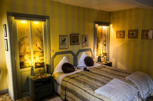a bedroom with a large bed with two pillows at " Chimay B & B " - ptits déj gourmands proposés in Chimay