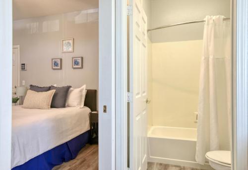a bedroom with a bed and a shower and a tub at Pacific Plaza #603 - Salty Studio - StudioD-Q in Oceano
