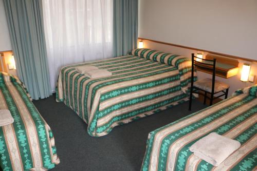 Postel nebo postele na pokoji v ubytování Hermitage Motel