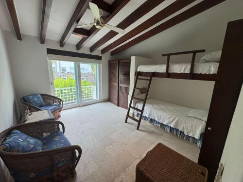 a room with two bunk beds and a window at Exclusive Luxury Waterfront Villa in Marina Real in Zihuatanejo